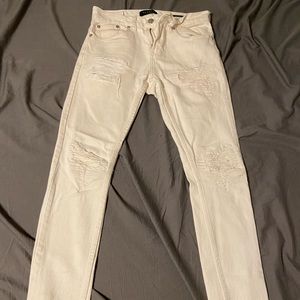 Stacked white to cream skinny jeans.